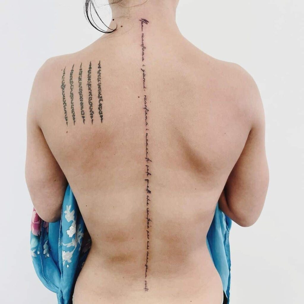 Tattoo with inscription on the spine for women