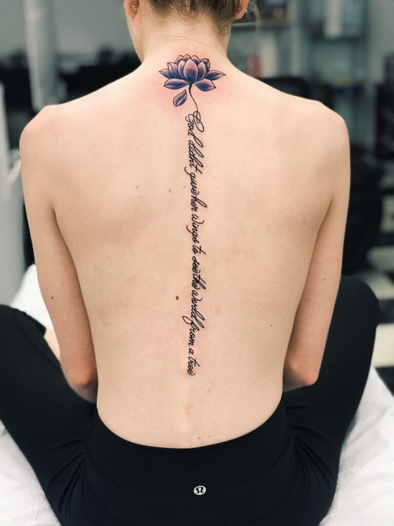 Tattoo with inscription on the spine for women