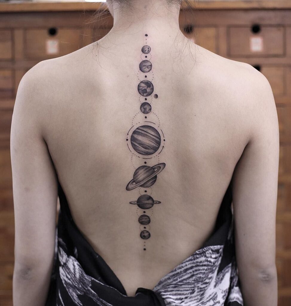 Tattoo of planets on the spine for women