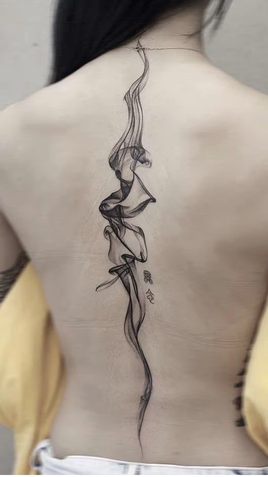 Large tattoo on the spine for women