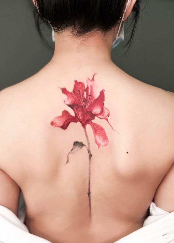 Color tattoo on the spine for women