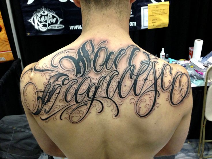 Calligraphy tattoo on the back for men