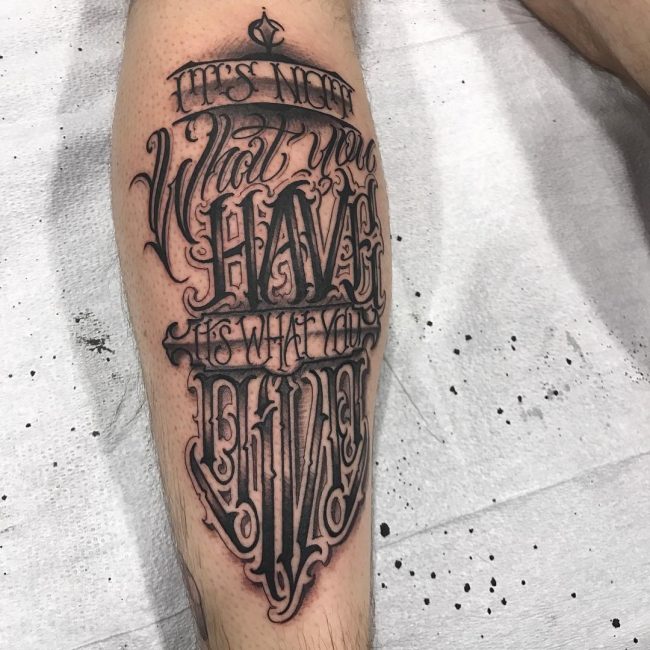 Calligraphy style tattoo on calves for men