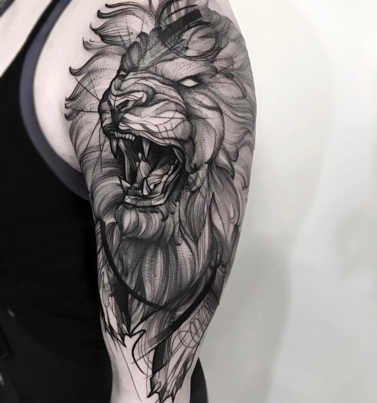 Large graphic style lion tattoo on the arm for men