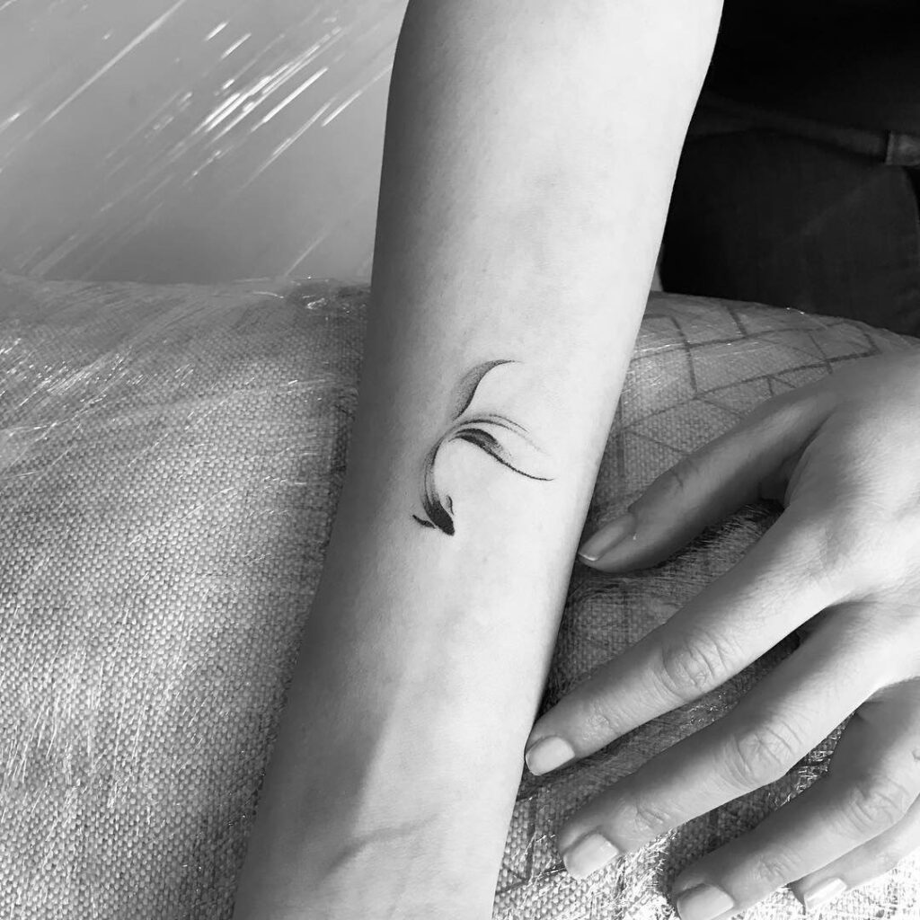 Fish tattoo on the arm for women