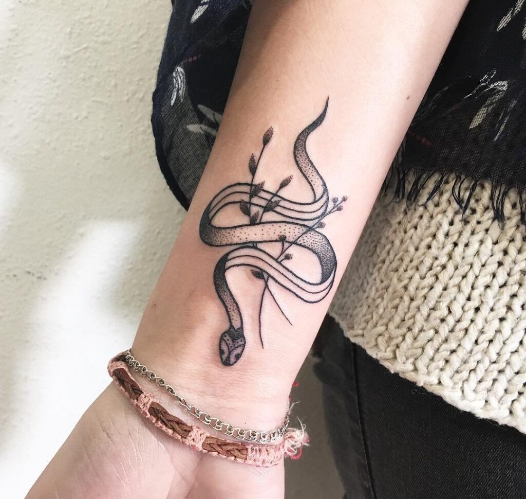 Snake tattoo on the arm for women