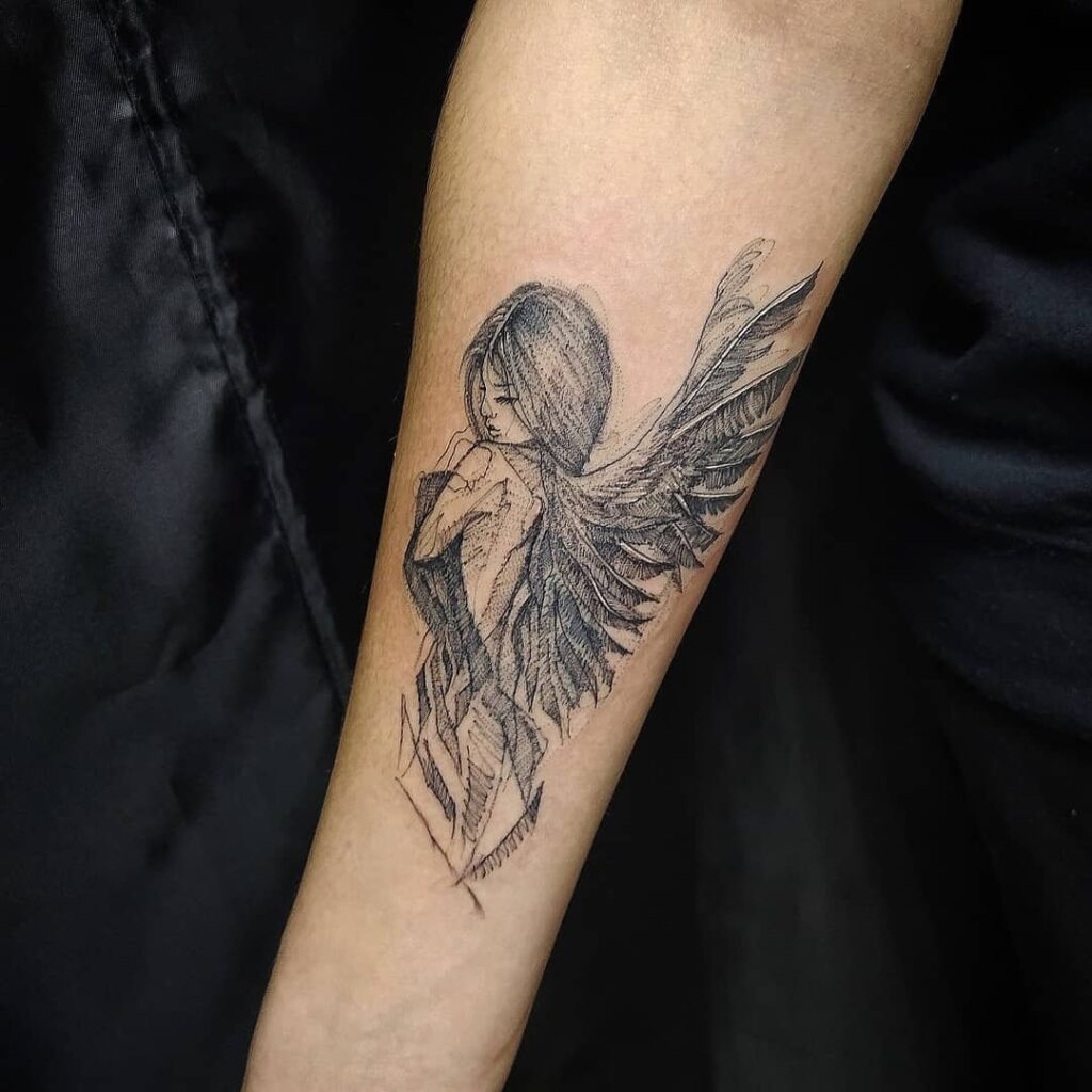 Angel tattoo on the arm for women