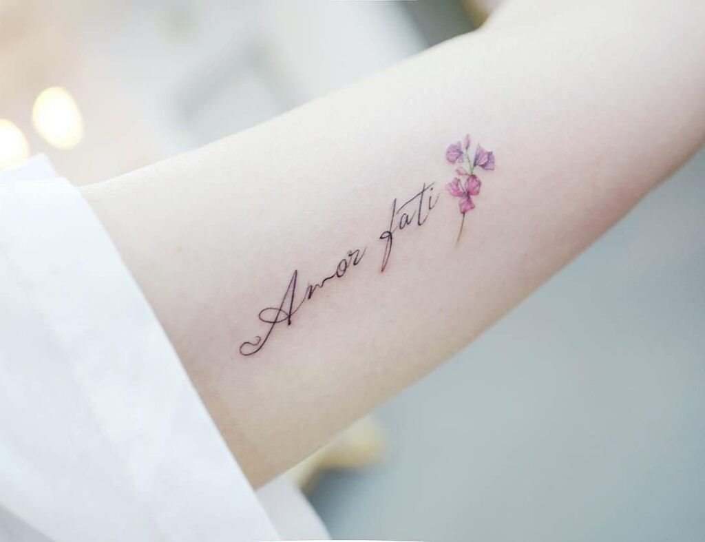 Tattoo with an inscription on the arm for women