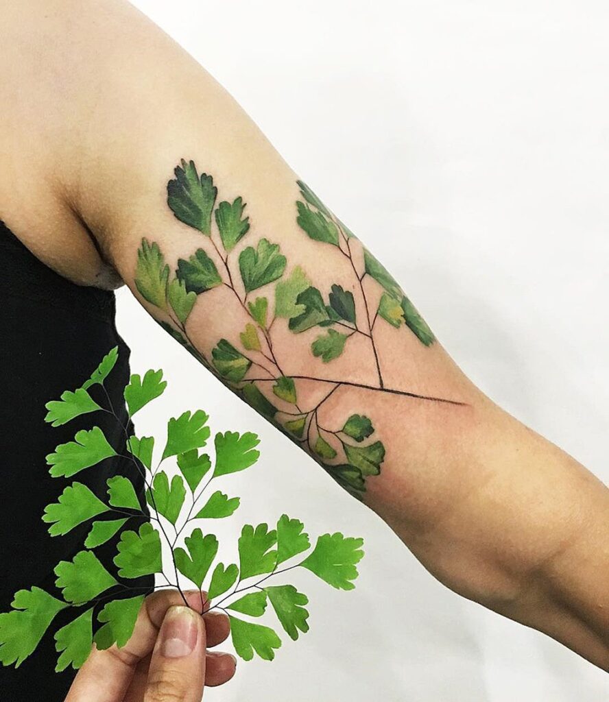 Colorful leaf tattoo on the arm for women