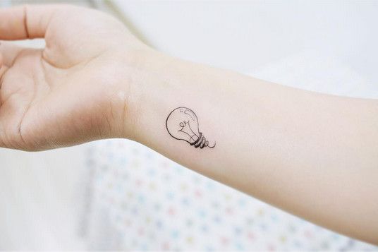 Tattoo of a light bulb on the arm for women