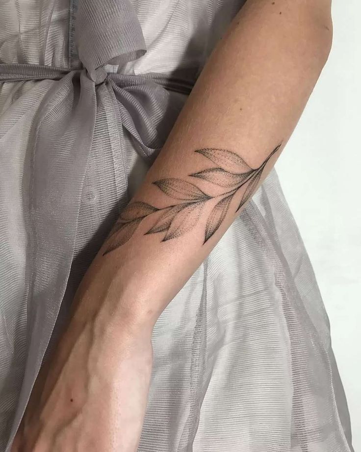 Tattoo of leaves on the arm for women