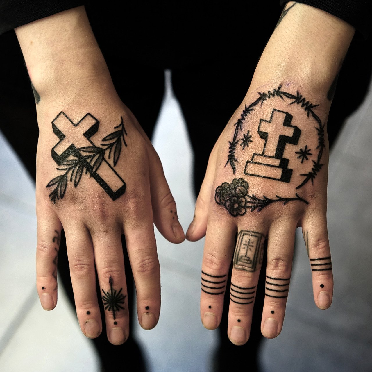 Tattoo of two crosses on the hand for women