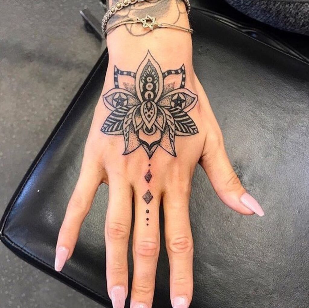 Large lotus tattoo on the hand for women