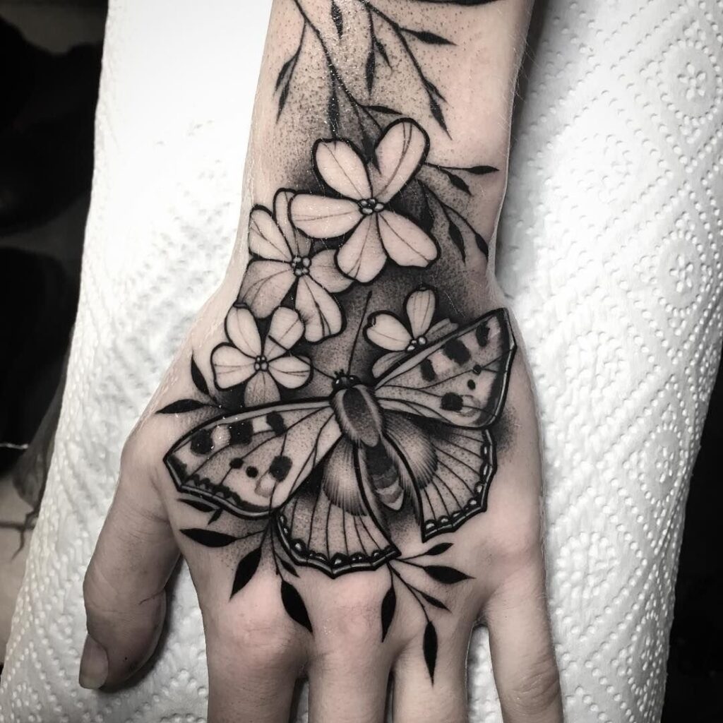 Large butterfly and flower tattoo on the brush for women