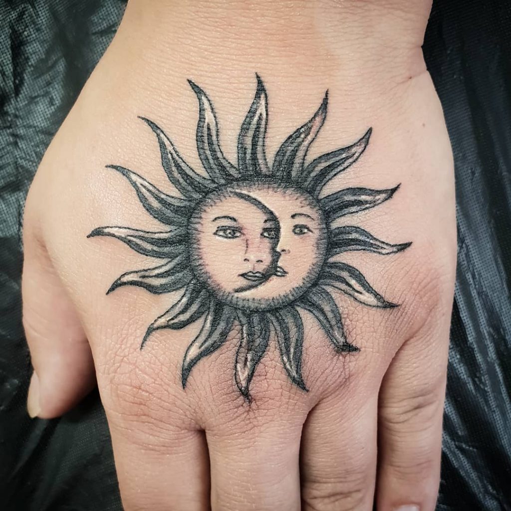 Sun and moon tattoo on the hand for women