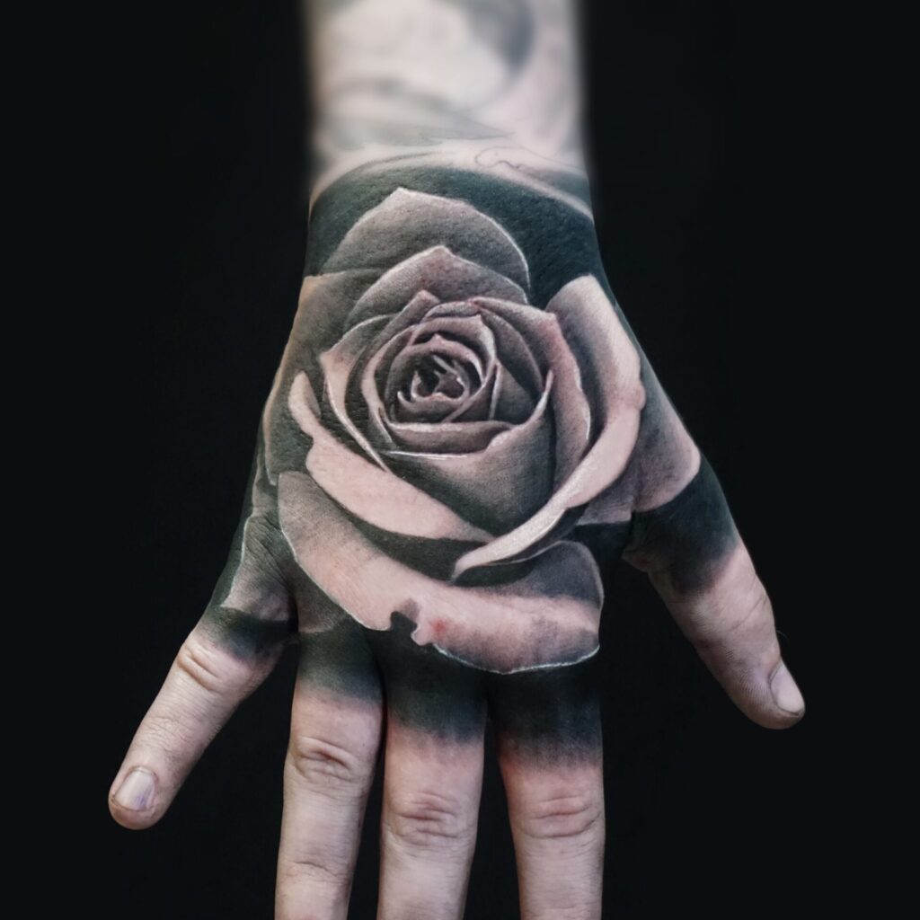 Rose tattoo on the hand for women