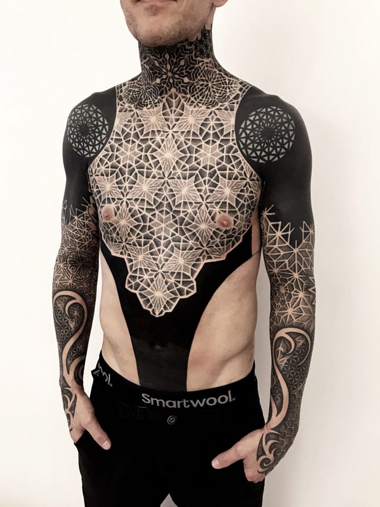 Blackwork style tattoo on the abdomen for men