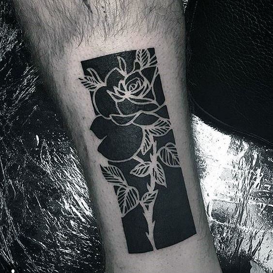 Blackwork rose tattoo on the leg for men