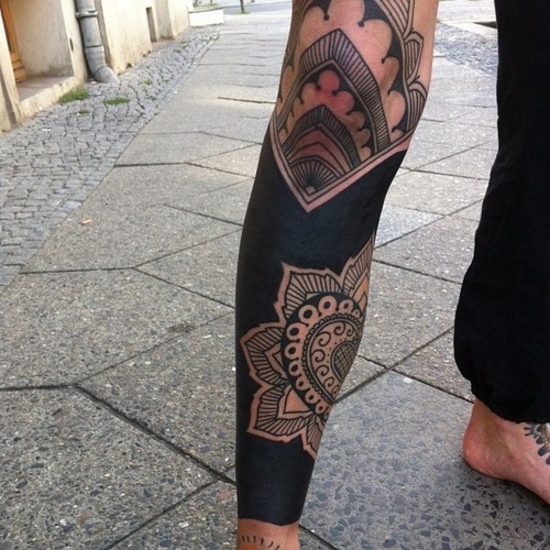 Blackwork style tattoo on the leg for men