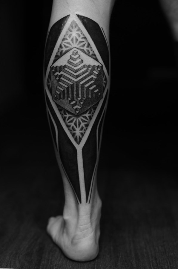 Blackwork style tattoo on the calf for men