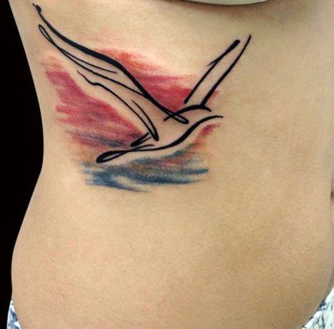 Art brut style seagull tattoo on the abdomen for women