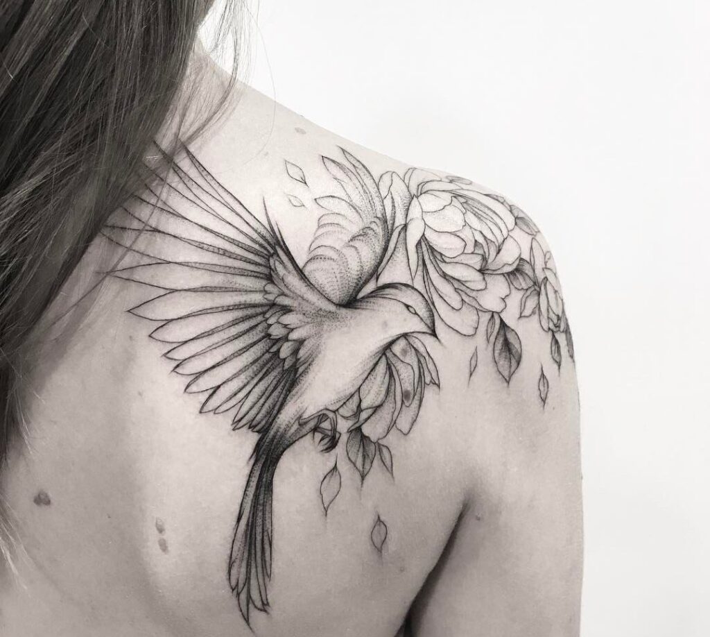 Large bird tattoo on the shoulder blade for women