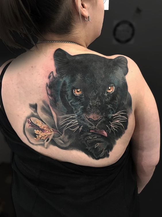 Large panther tattoo on the shoulder blade for women