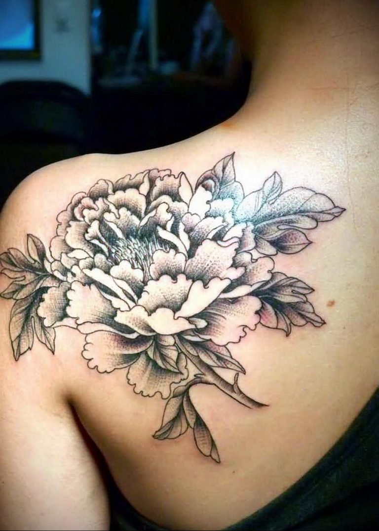 Large flower tattoo on the shoulder blade for women