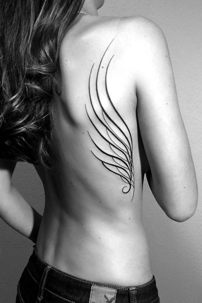 Wing tattoo on the shoulder blade for women