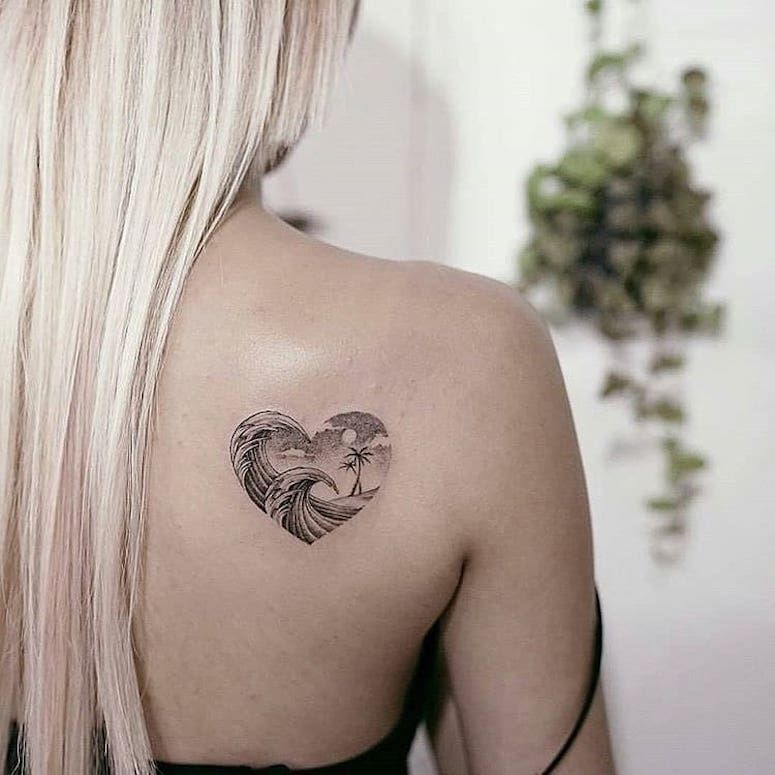 Wave tattoo on the shoulder blade for women