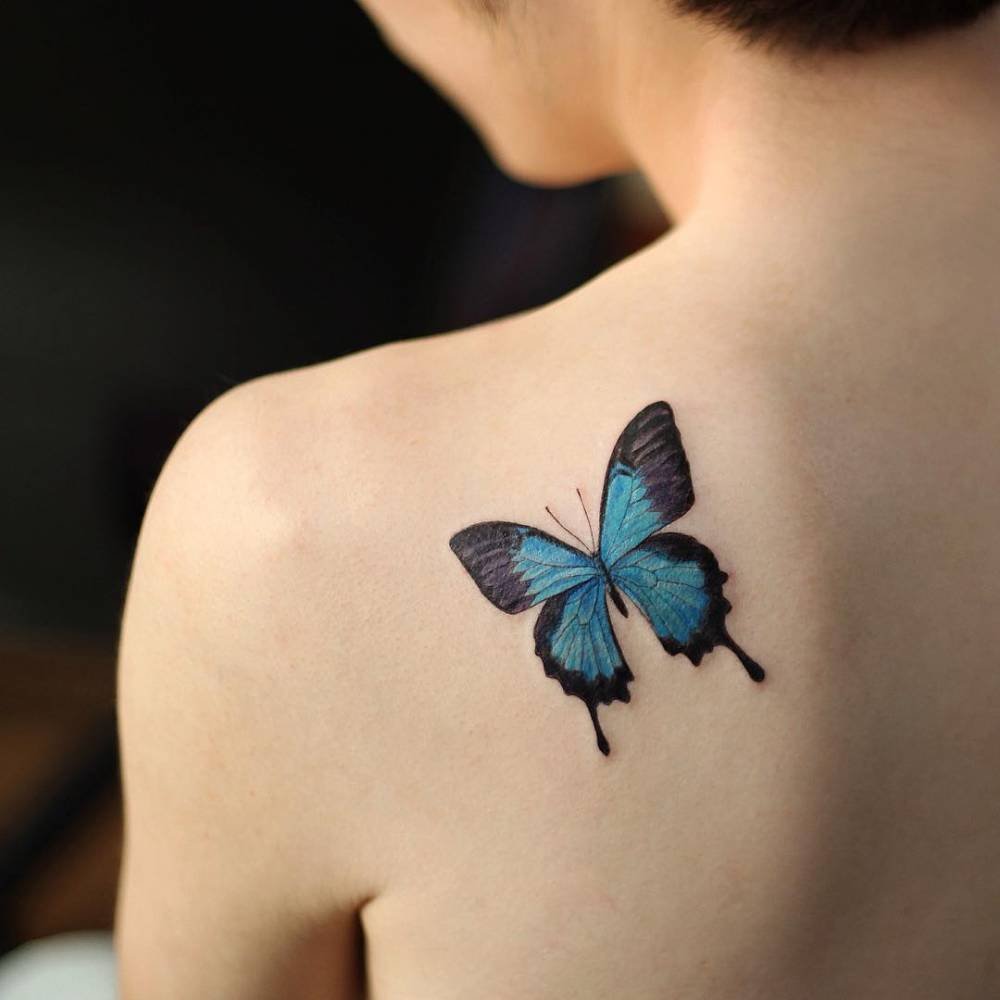 Butterfly tattoo on the shoulder blade for women