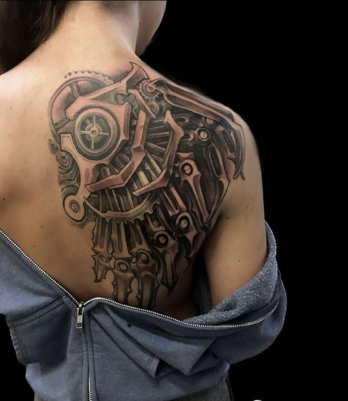 Biomechanics style tattoo on the shoulder blade for women