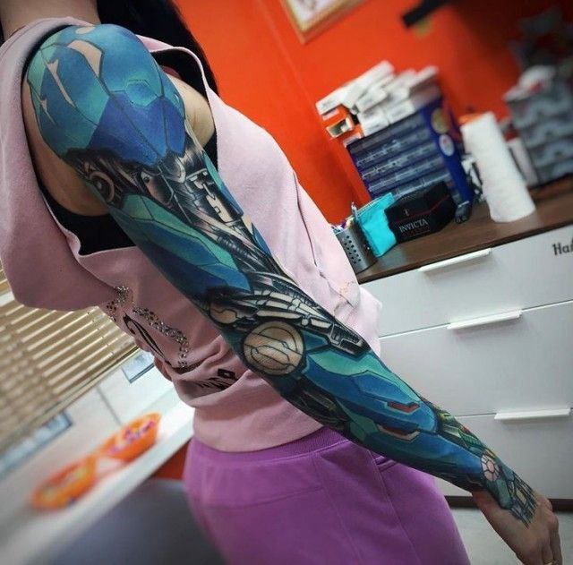 Colored tattoo in the style of biomechanics on the arm for women