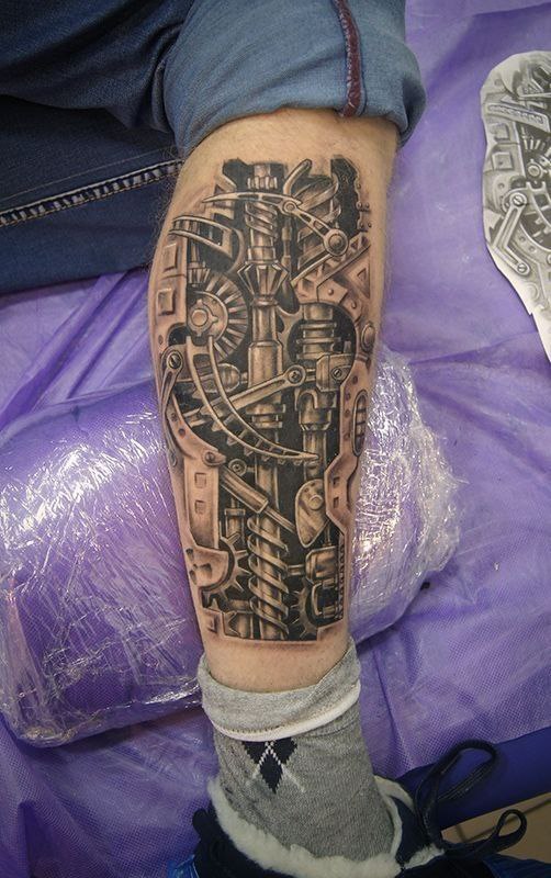 Biomechanics style tattoo on the leg for men