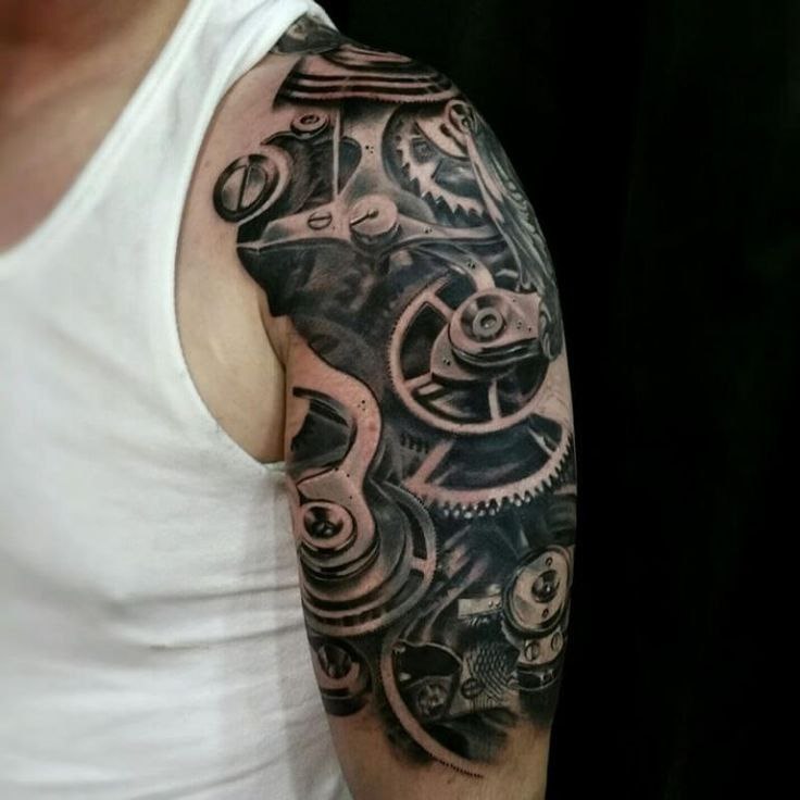 Biomechanics style tattoo on the shoulder for men