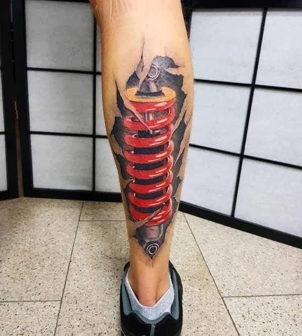 Color biomechanics style tattoo on the calf for men