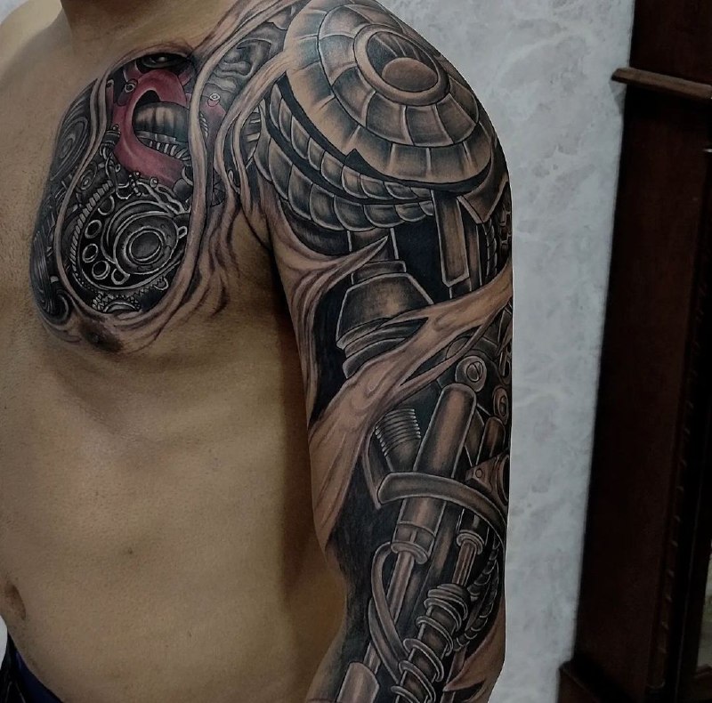 Biomechanics style tattoo on the arm for men