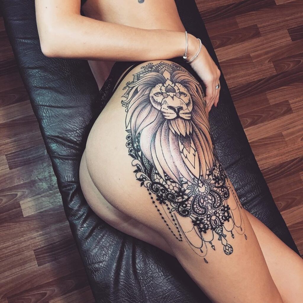 Large lion tattoo on the thigh for women