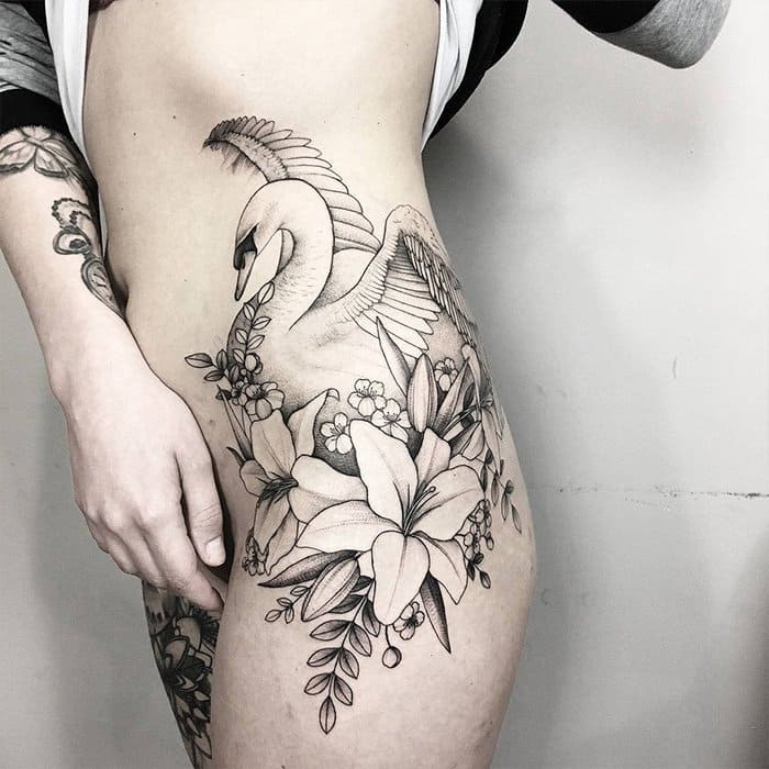 Tattoo of a swan and flowers on the thigh for women