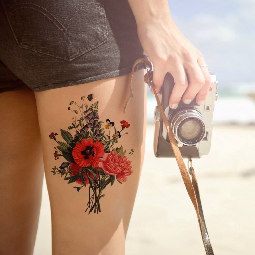 Flower tattoo on the hip for women