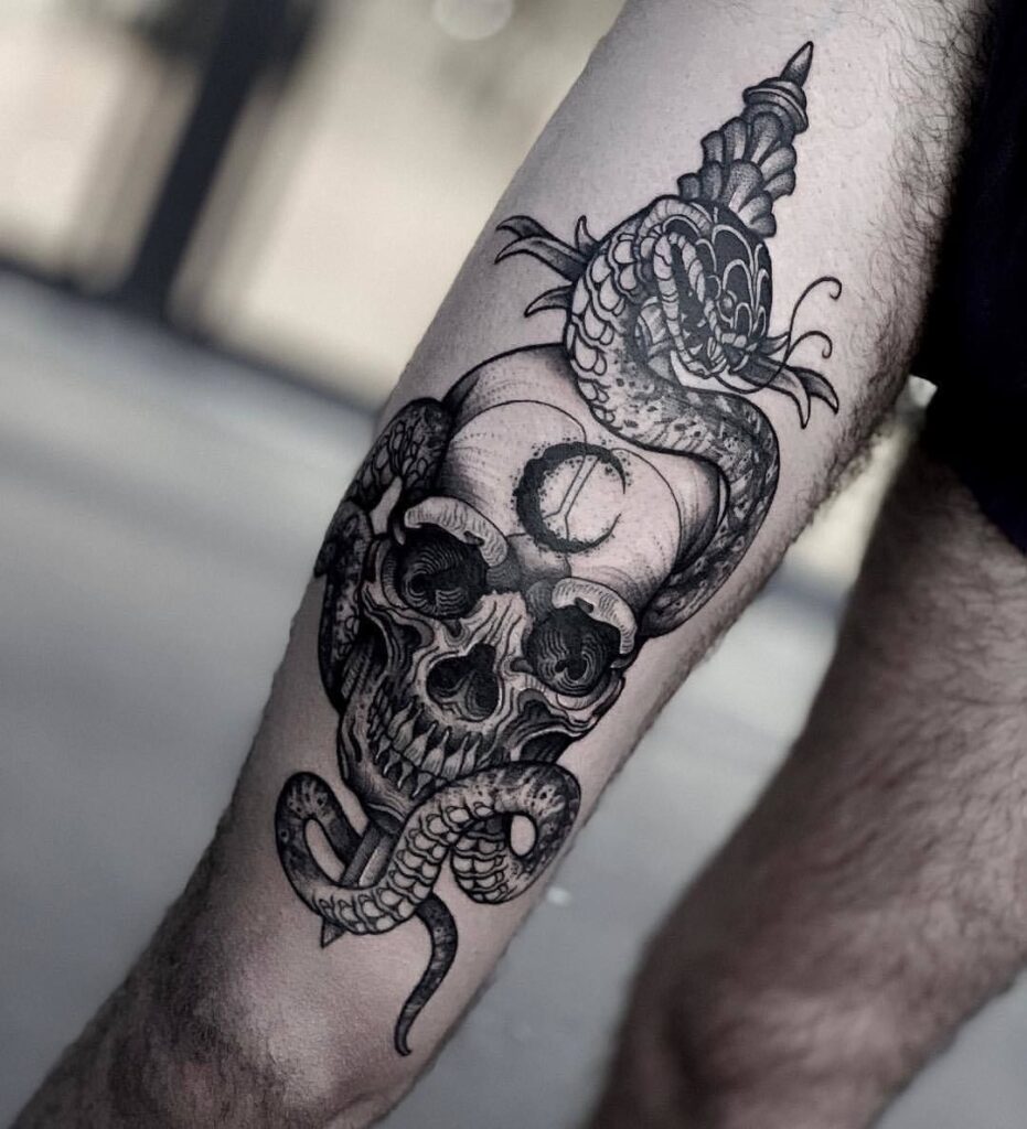 Skull and snake tattoo on the hip for men