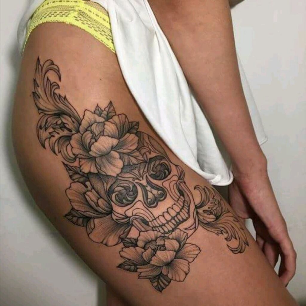 Large skull tattoo on the hip for women