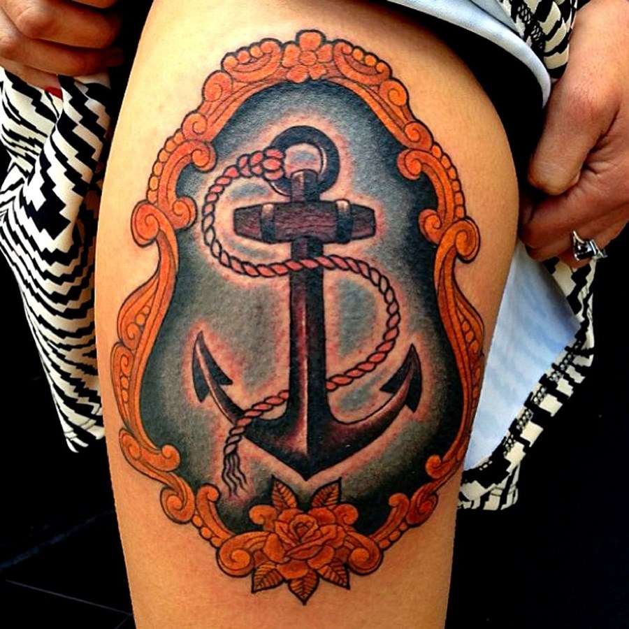 Colored anchor tattoo on the hip for men