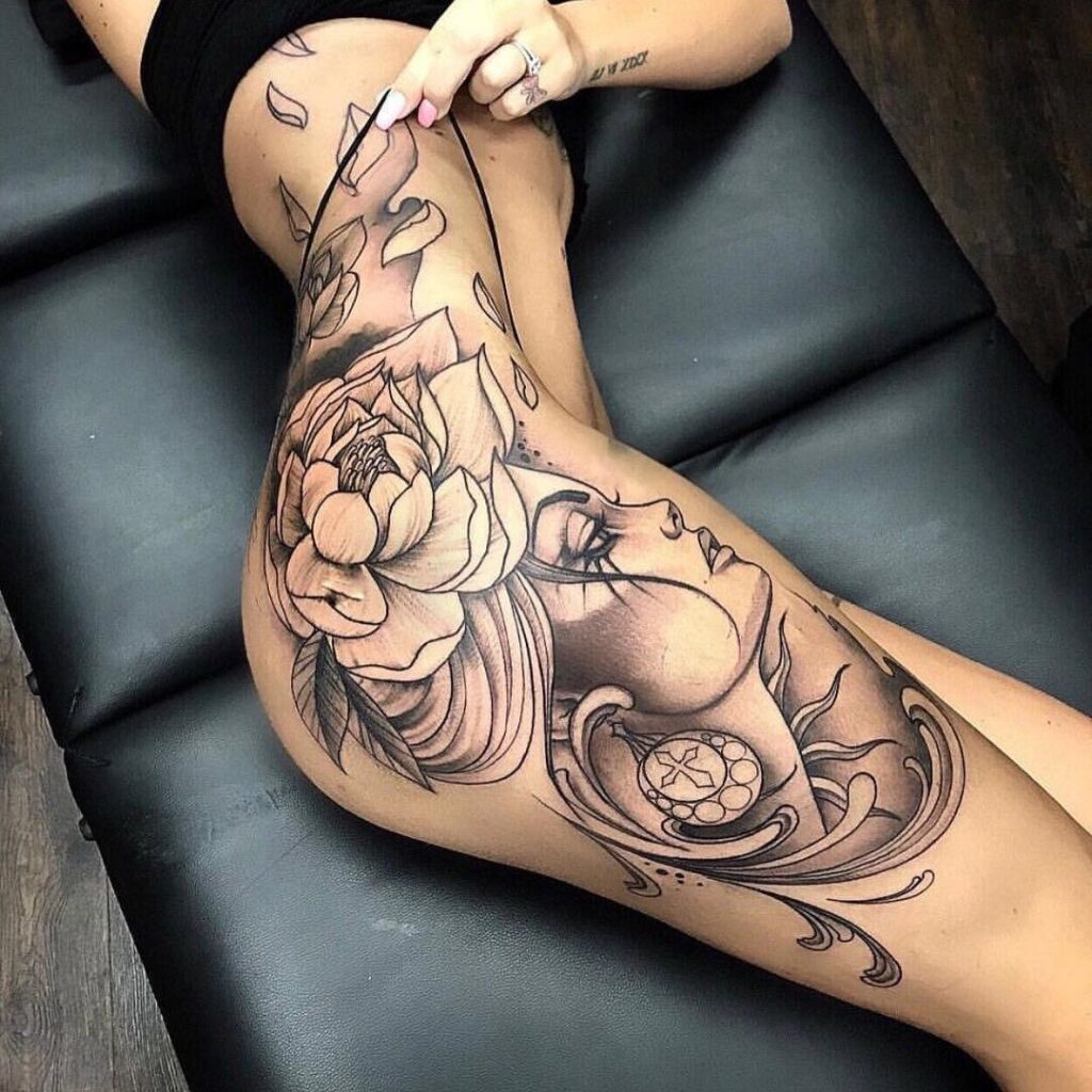 Large tattoo of a girl with flowers on her hip for women