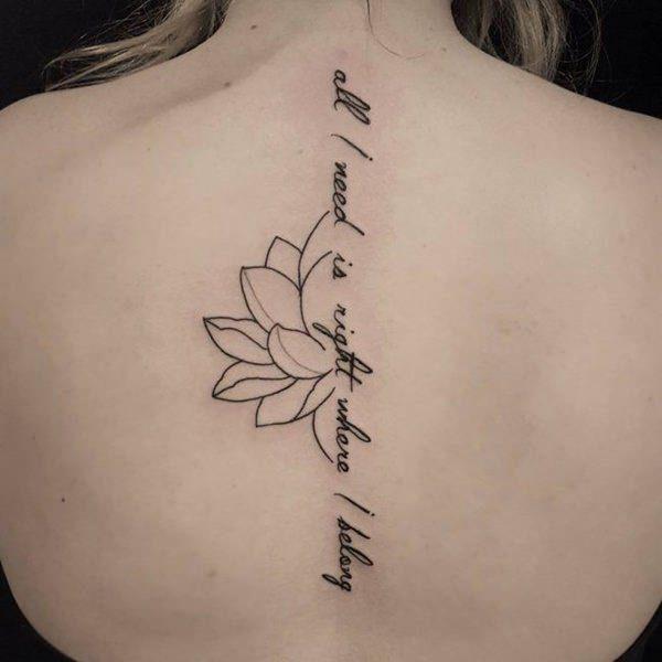 Tattoo with inscription on the spine for women