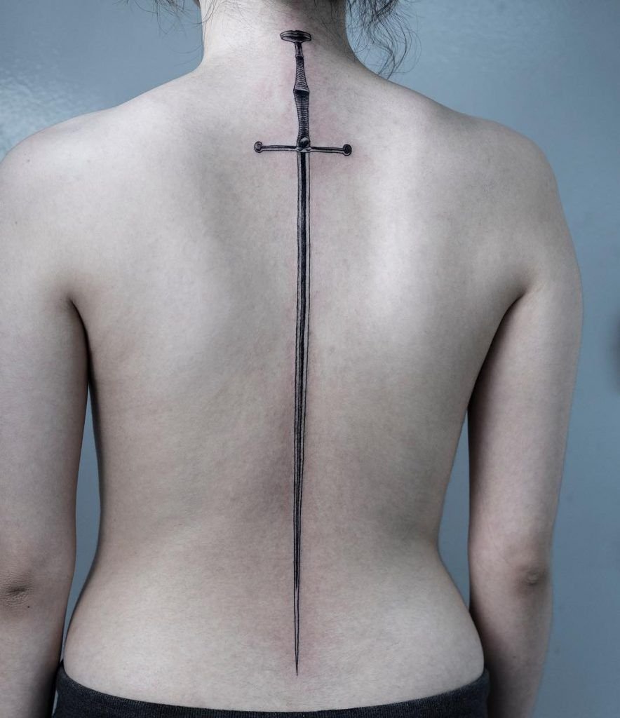 Sword tattoo on the spine for women