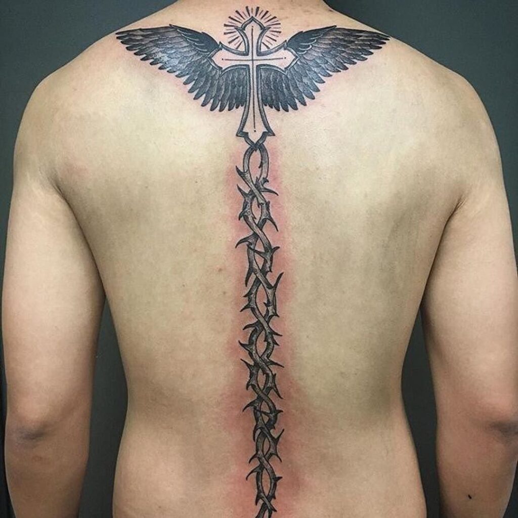 Large cross tattoo on the spine for men