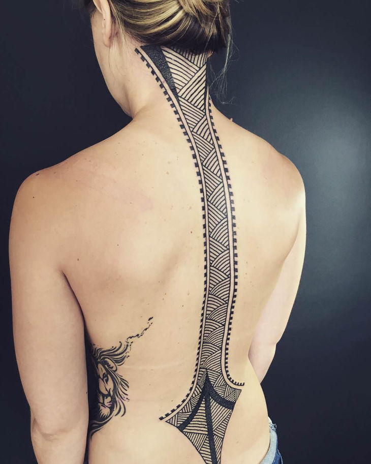 Large tattoo on the spine for women