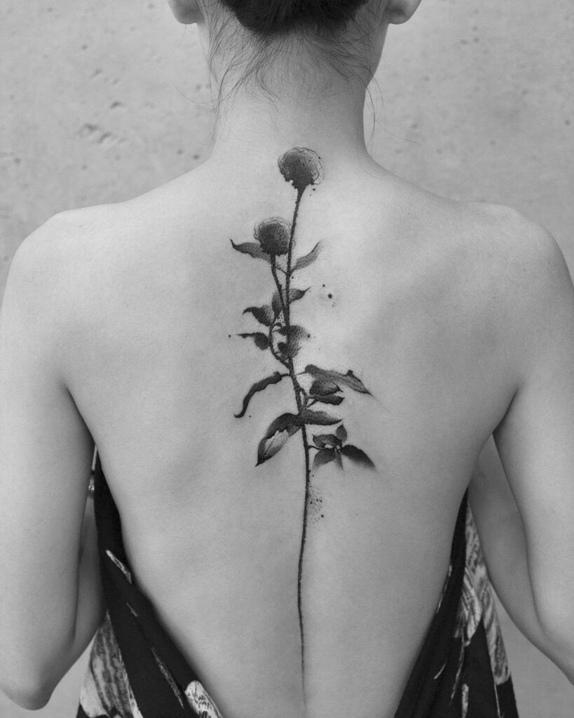 Flower tattoo on the spine for women