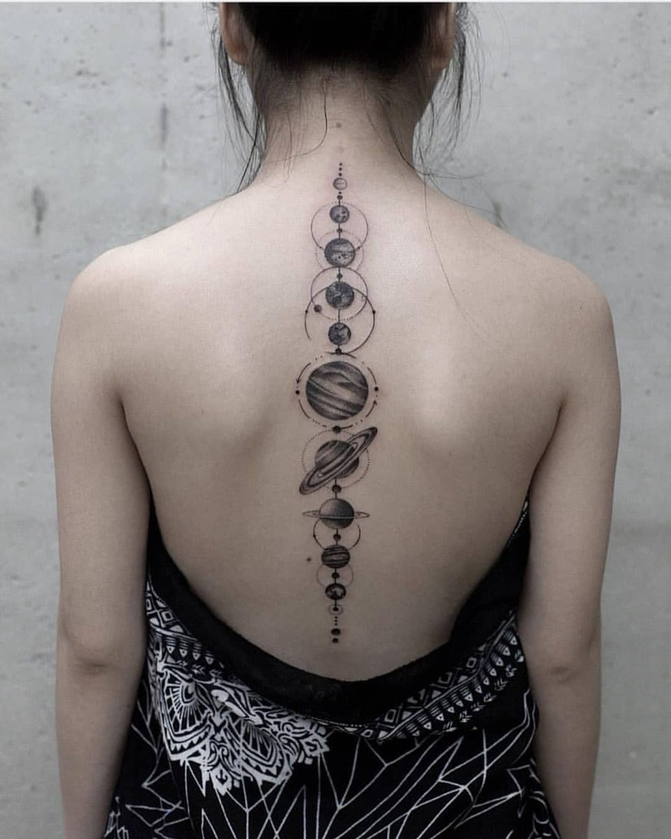 Tattoo of planets on the spine for women